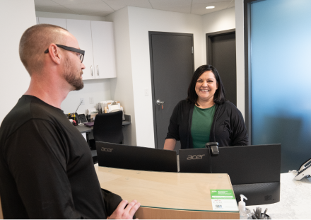 Patient talking to front desk employee